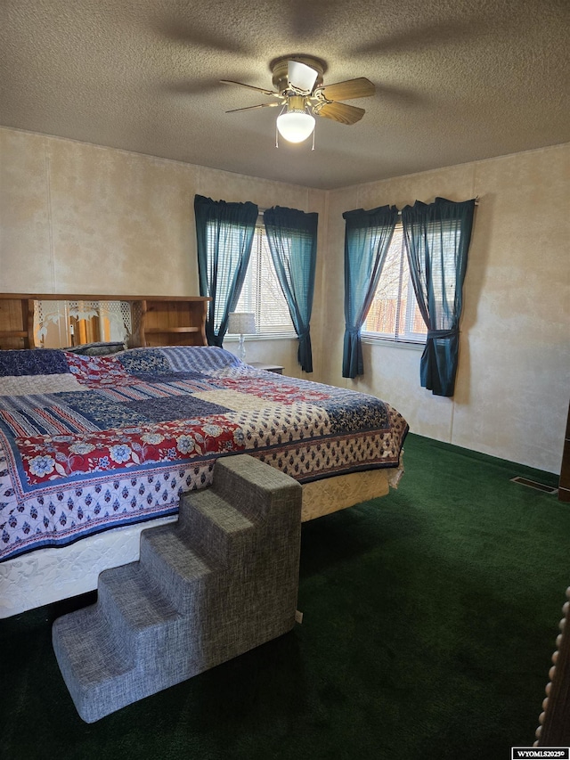 716 E 3rd St, Marbleton, WY 83113 - carpeted bedroom with a ceiling fan and a textured ceiling