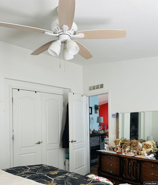 65 Eagle Ln, Lyman, WY 82937 - bedroom with a fireplace, vaulted ceiling, ceiling fan, and a closet