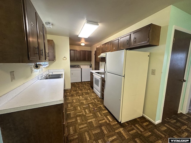 kitchen with white appliances, washing machine and clothes dryer, dark brown cabinets, and under cabinet range hood