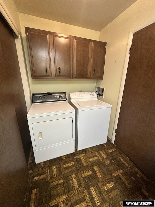 clothes washing area with cabinet space and washer and clothes dryer
