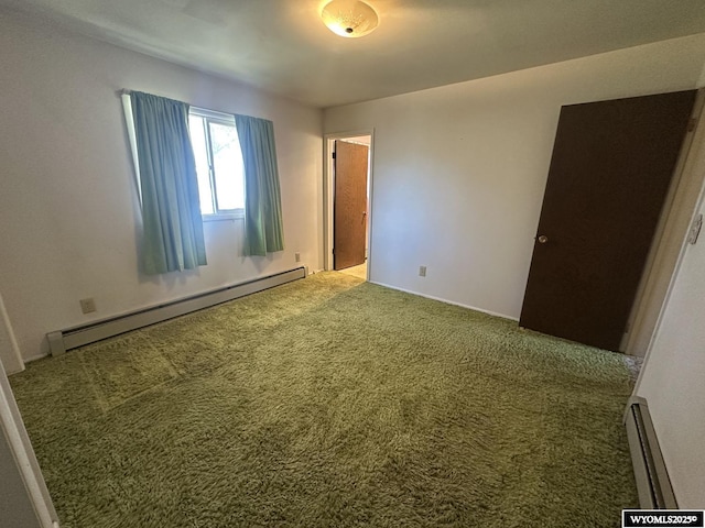 unfurnished bedroom featuring a baseboard heating unit, carpet floors, and baseboards