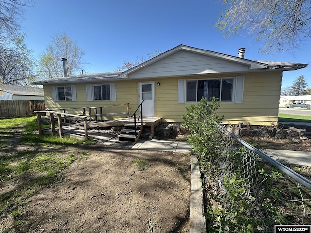 back of house featuring fence