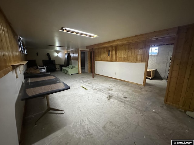below grade area featuring a wood stove and wooden walls