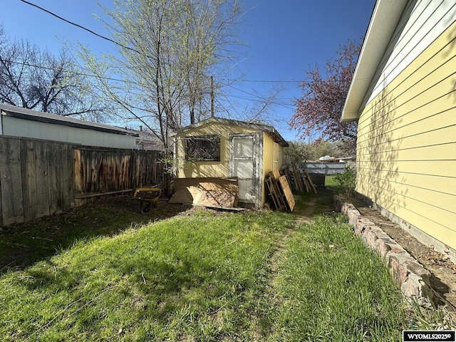 view of yard featuring a storage unit and an outdoor structure