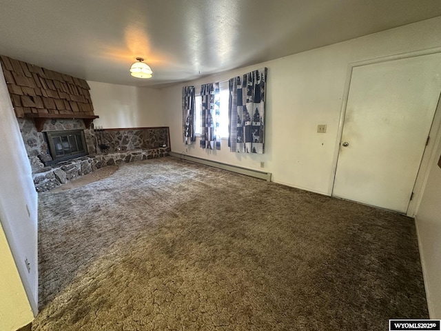 unfurnished living room with baseboard heating, carpet floors, and a fireplace