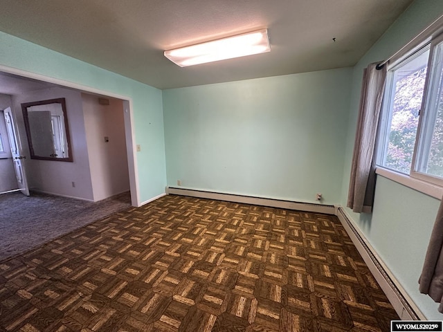 empty room featuring a baseboard heating unit