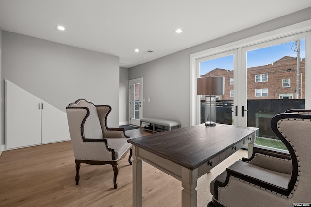 dining area with light wood-style floors, plenty of natural light, recessed lighting, and french doors