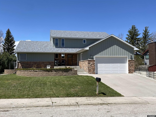 4230 S Oak St, Casper, WY 82601 - view of front facade featuring an attached garage, concrete driveway, roof with shingles, and stone siding