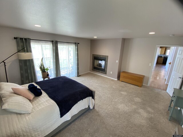 4230 S Oak St, Casper, WY 82601 - bedroom featuring recessed lighting, light carpet, baseboards, and a glass covered fireplace