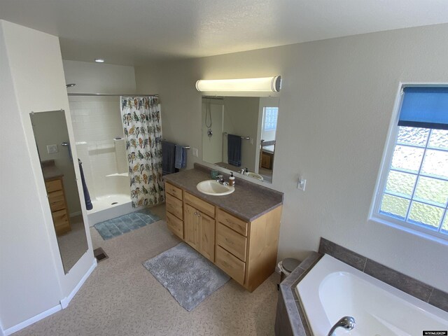 4230 S Oak St, Casper, WY 82601 - bathroom featuring a shower stall, vanity, and a garden tub