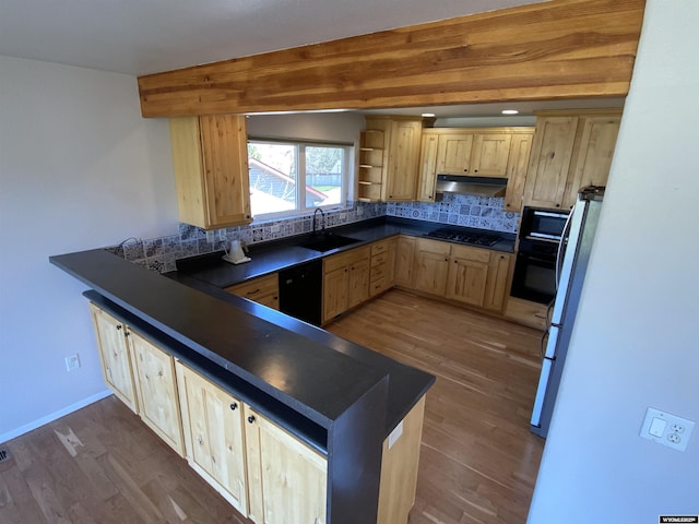 4230 S Oak St, Casper, WY 82601 - kitchen featuring light brown cabinetry, under cabinet range hood, black appliances, dark countertops, and a peninsula