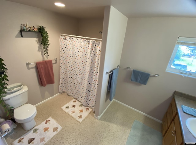 4230 S Oak St, Casper, WY 82601 - bathroom with curtained shower, toilet, vanity, baseboards, and recessed lighting