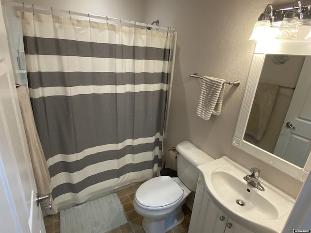 4230 S Oak St, Casper, WY 82601 - bathroom with toilet, a textured wall, tile patterned flooring, a shower with curtain, and vanity