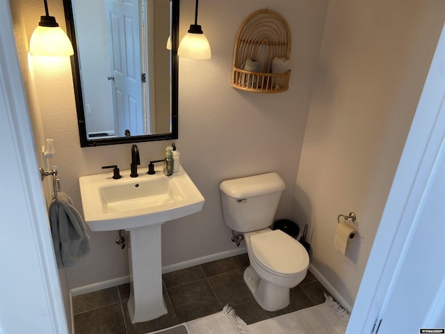 4230 S Oak St, Casper, WY 82601 - bathroom featuring toilet, tile patterned flooring, and baseboards