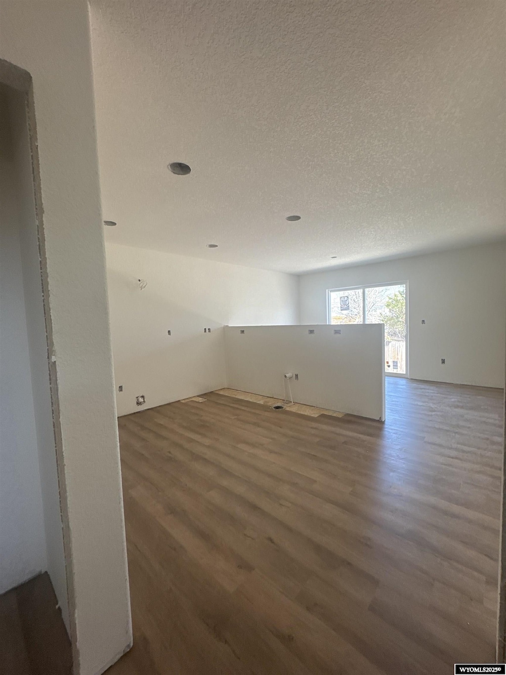 empty room featuring wood finished floors and a textured ceiling