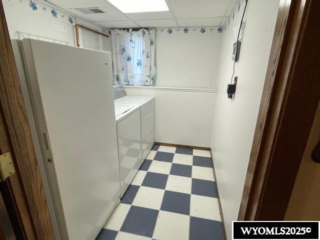laundry area with light flooring and washer and clothes dryer