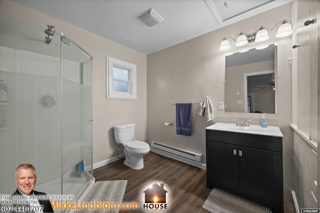 full bathroom featuring a baseboard radiator, a stall shower, wood finished floors, toilet, and vanity