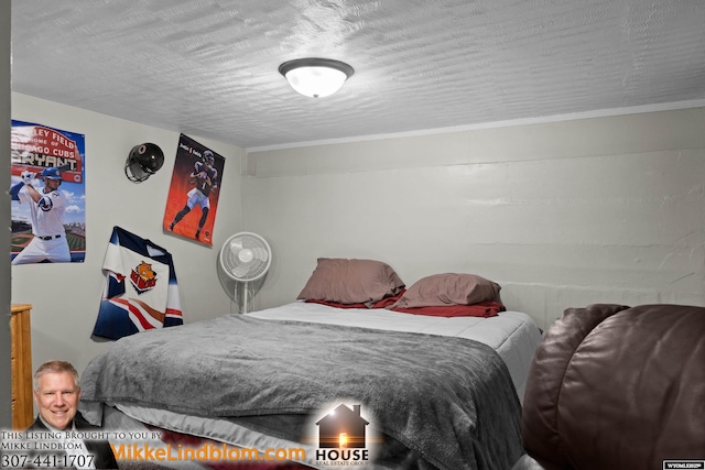 bedroom featuring ornamental molding and a textured ceiling