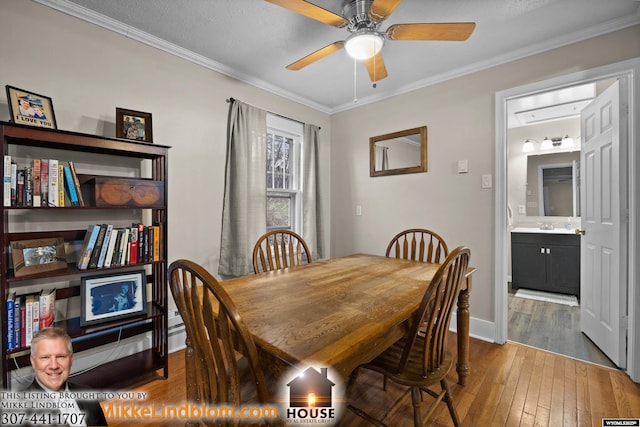 dining room featuring hardwood / wood-style flooring, crown molding, a ceiling fan, and baseboards