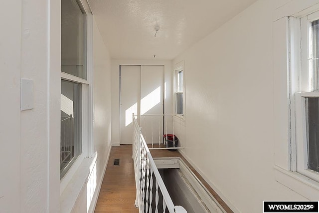 330 M St, Rock Springs, WY 82901 - corridor featuring wood finished floors, healthy amount of natural light, and baseboards