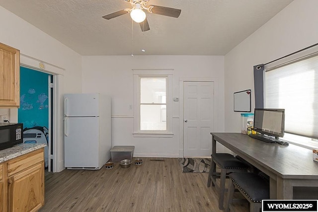 330 M St, Rock Springs, WY 82901 - kitchen with freestanding refrigerator, black microwave, dark wood-style flooring, and a ceiling fan