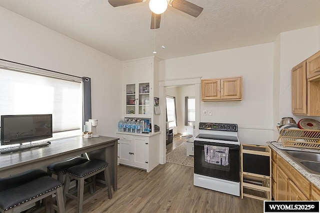 330 M St, Rock Springs, WY 82901 - kitchen featuring electric range, ceiling fan, light wood-type flooring, a desk, and a sink