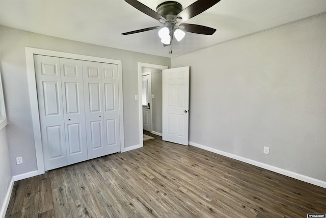 unfurnished bedroom featuring baseboards and wood finished floors