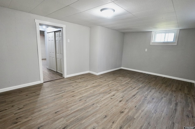 below grade area featuring wood finished floors and baseboards
