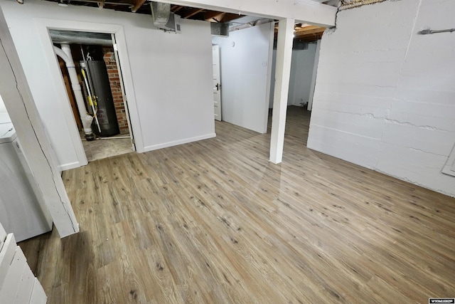 finished basement with gas water heater and light wood finished floors