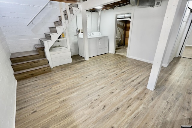 finished basement with independent washer and dryer, stairway, wood finished floors, and baseboards