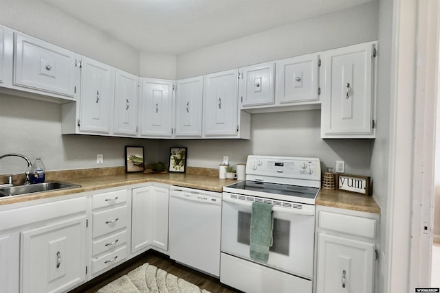 kitchen featuring white appliances, a sink, and white cabinets