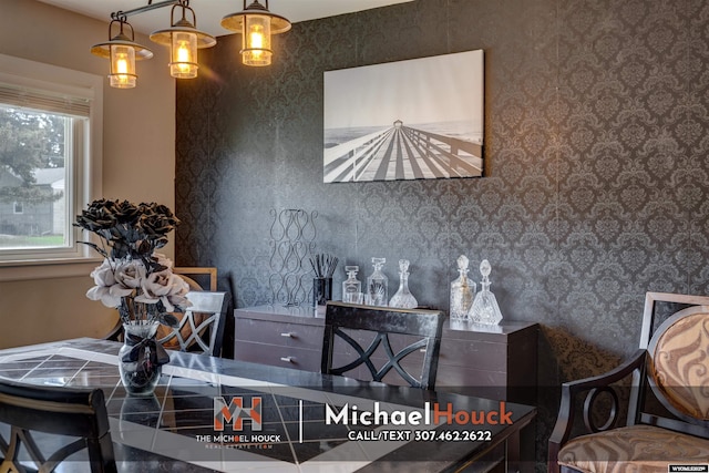 dining space featuring wallpapered walls and plenty of natural light
