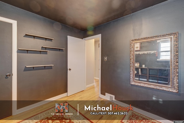 entrance foyer with wood finished floors and baseboards