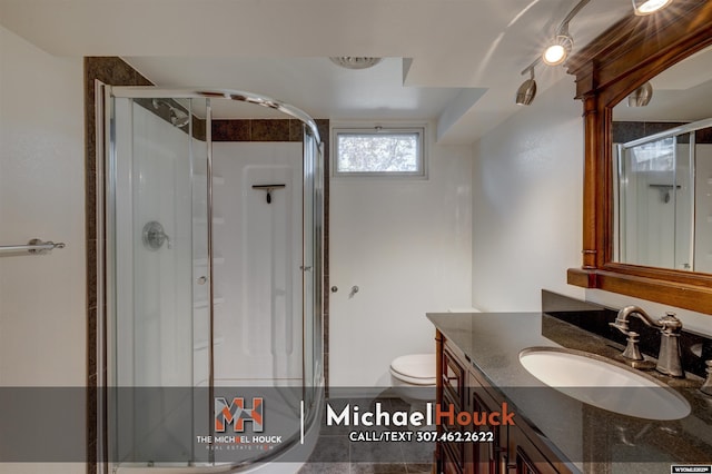 bathroom featuring a stall shower, vanity, toilet, and tile patterned flooring