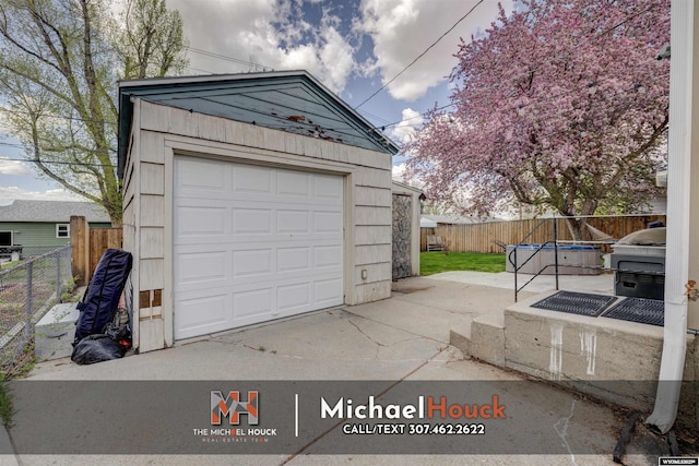 detached garage featuring fence