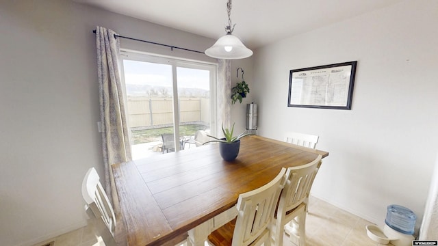 dining area featuring baseboards and light tile patterned floors