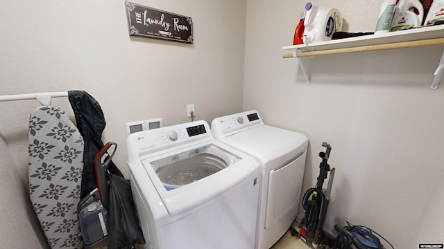 clothes washing area with washing machine and dryer