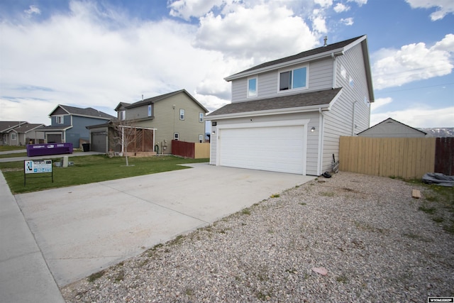 traditional home featuring concrete driveway and an attached garage