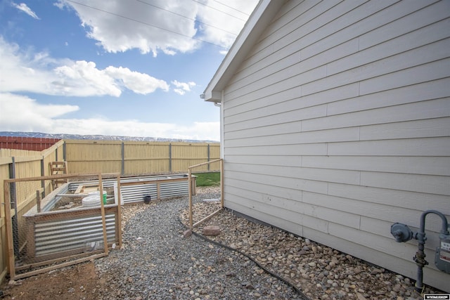 view of yard featuring fence and a vegetable garden