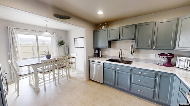 kitchen featuring dishwasher, a sink, light stone countertops, hanging light fixtures, and recessed lighting