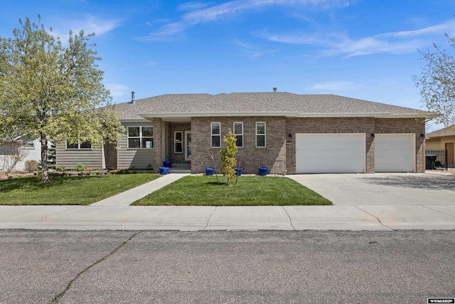 ranch-style home with an attached garage, a front lawn, concrete driveway, and brick siding