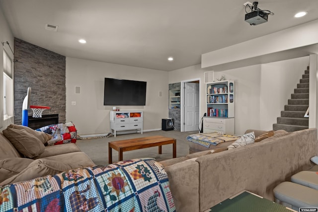 living room featuring stairway, carpet, recessed lighting, baseboards, and a stone fireplace
