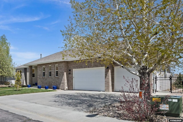 view of front facade with brick siding, driveway, an attached garage, and fence