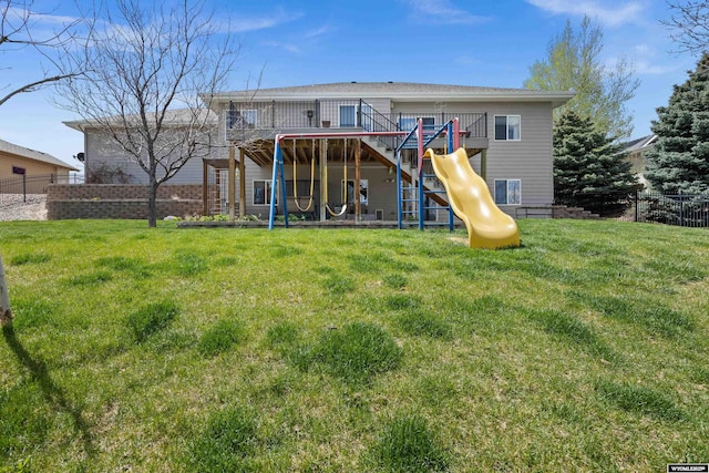 back of house with a playground
