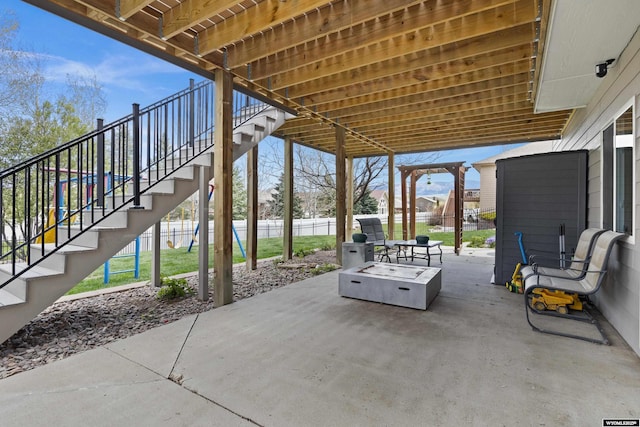 view of patio / terrace featuring stairs and fence