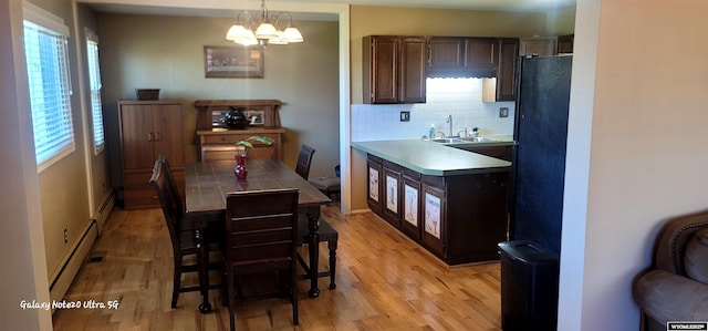 1630 De Smet Ave, Sheridan, WY 82801 - dining space with light wood-style floors, a baseboard heating unit, and baseboards