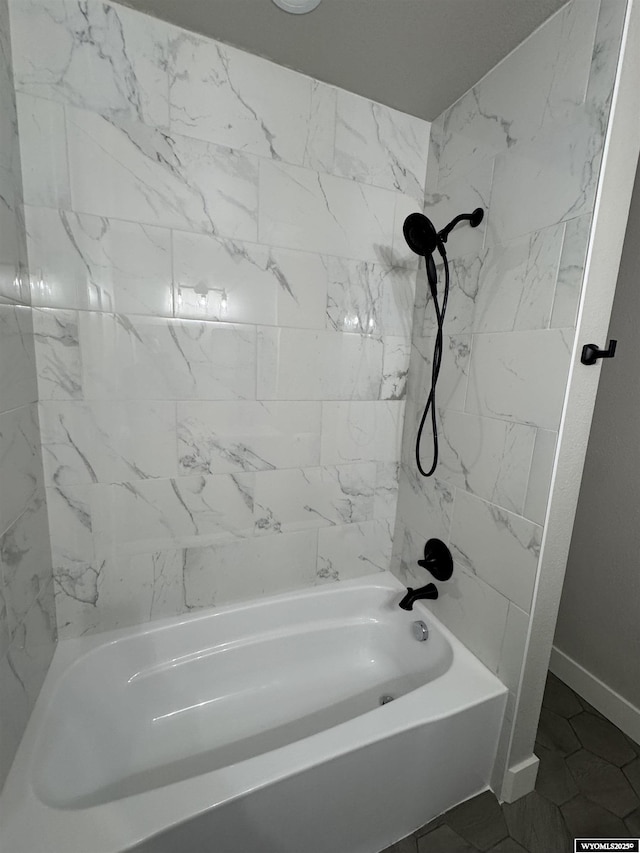 bathroom with baseboards and shower / bath combination