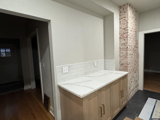 bathroom with wood finished floors and backsplash