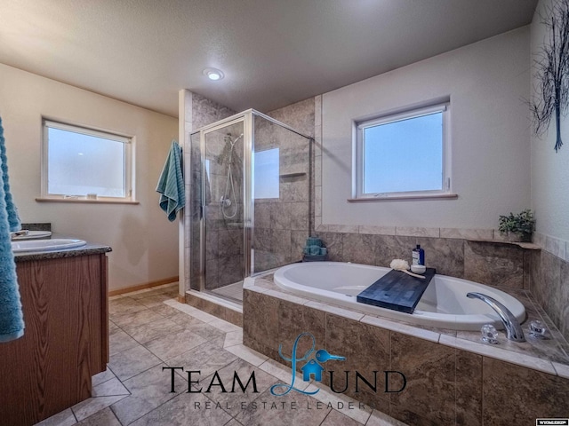 bathroom with a shower stall, a garden tub, tile patterned floors, vanity, and baseboards