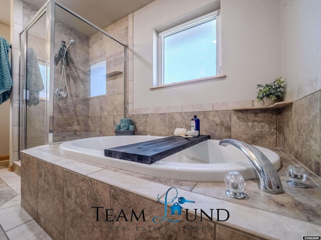 full bathroom with a stall shower and a garden tub